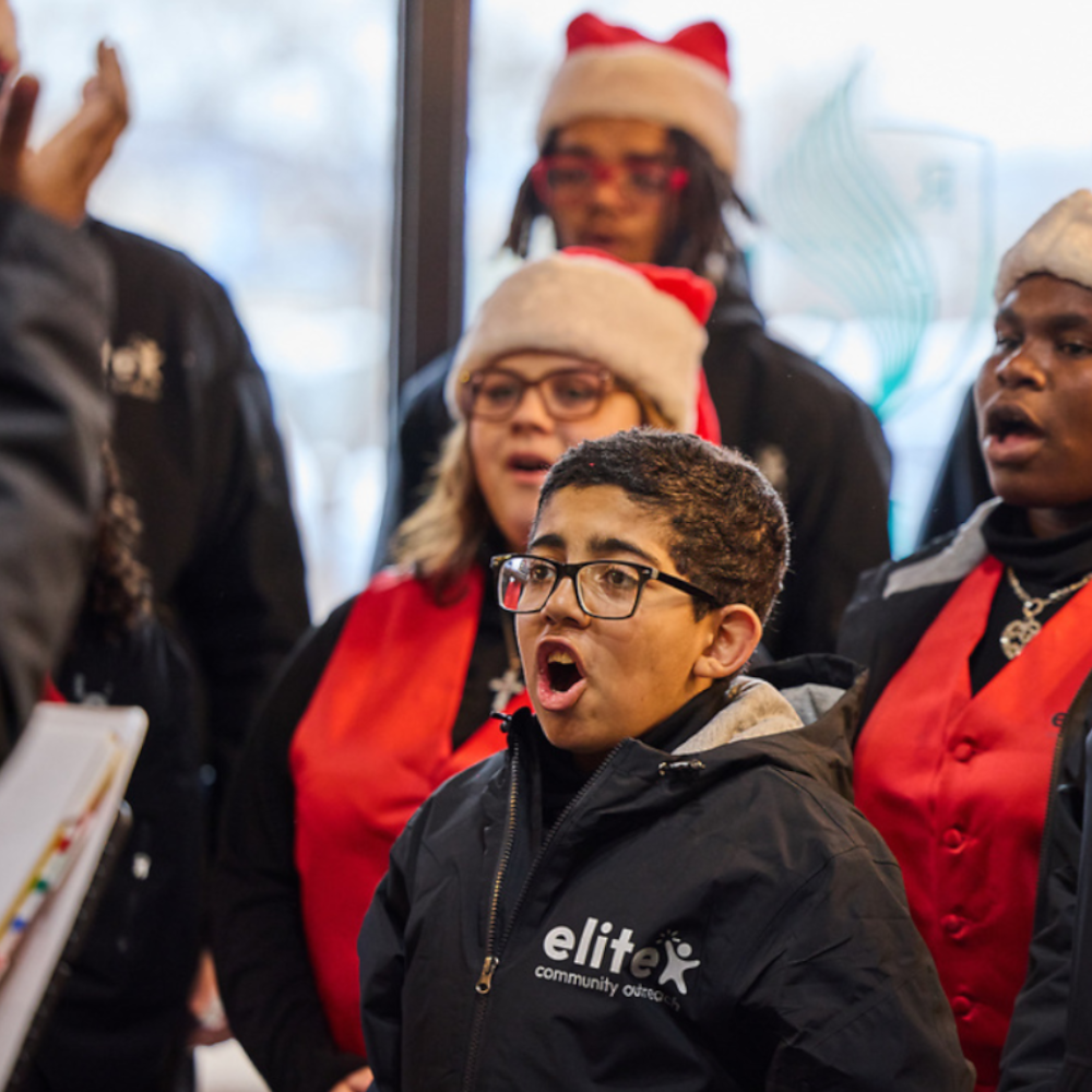 A child sings in the Elite Christmas Choir at the Chocolate Turkey race/walk event.