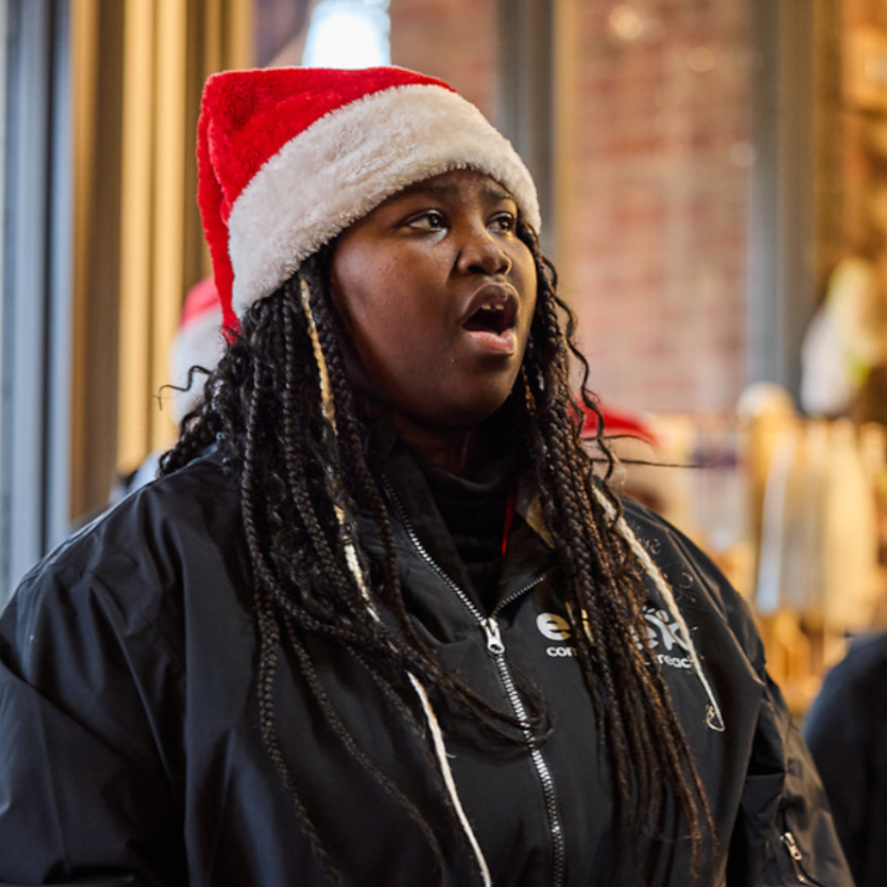 A member of the Elite Community Outreach Christmas Choir performs a solo.